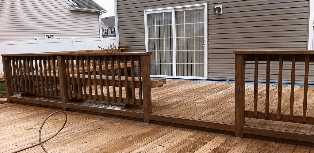 Deck sealing service protecting a backyard wood deck and railings in Minneapolis, MN