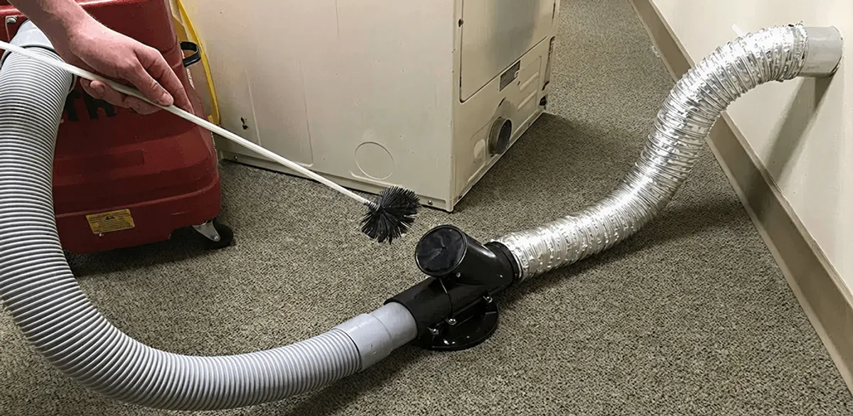 Dryer vent cleaning service removing lint from a dryer duct connection in Minneapolis, MN