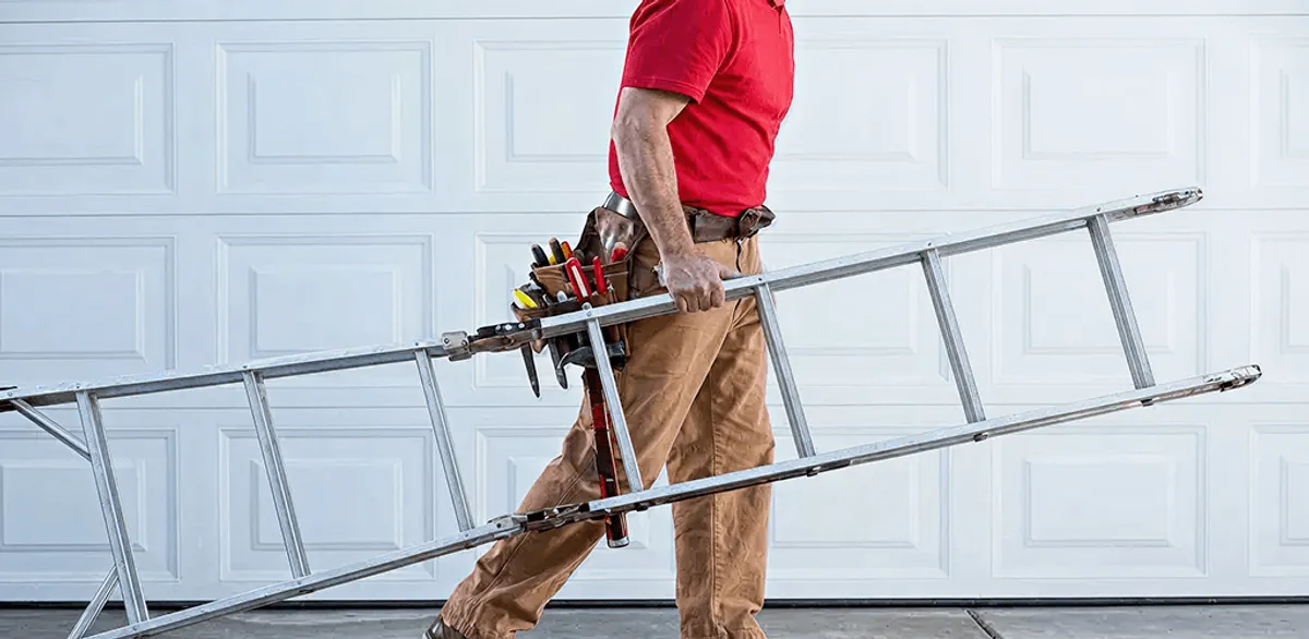 Garage door repair technician arriving with tools and ladder in Minneapolis, MN