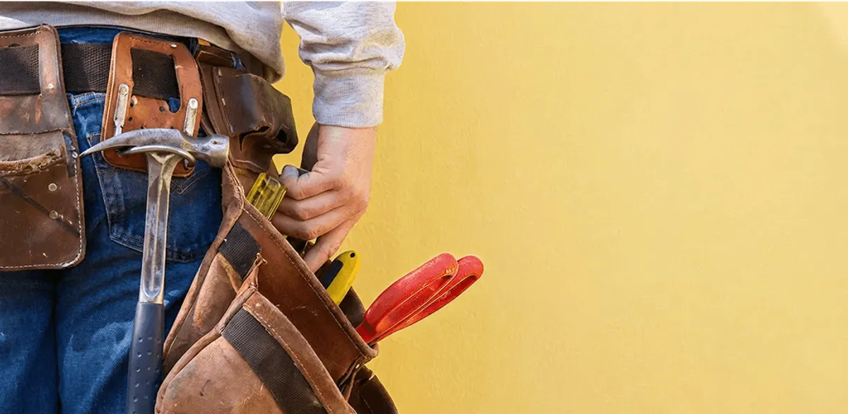 Handyman with tool belt ready for home repairs and maintenance in Minneapolis, MN