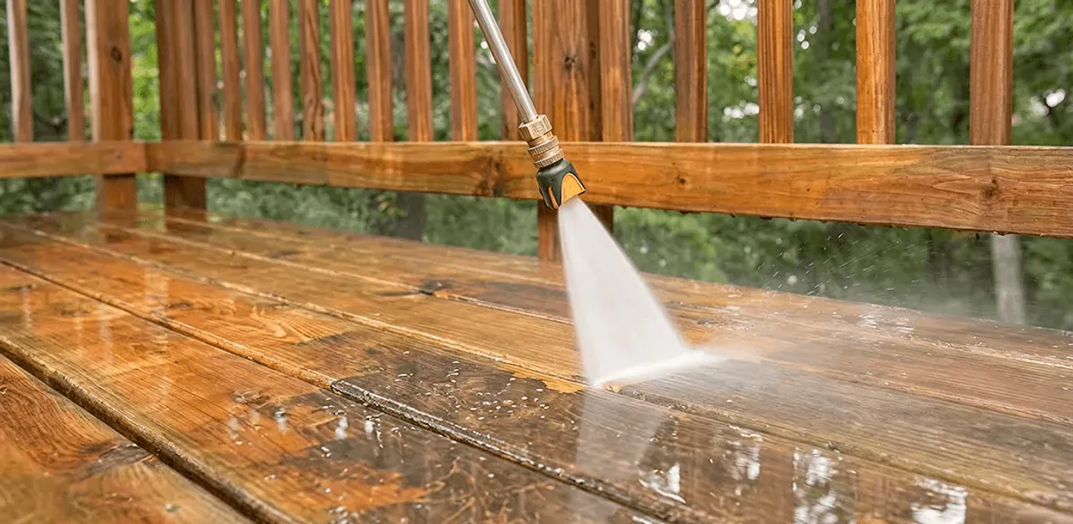 Pressure washing a wood deck to remove dirt and buildup in Minneapolis, MN