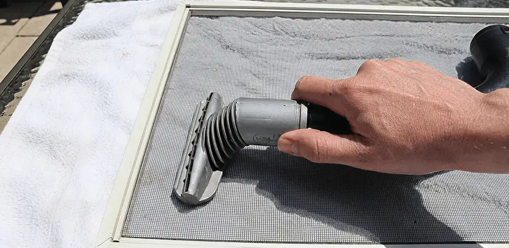 Window screen repair cleaning and fixing a damaged screen mesh in Minneapolis, MN